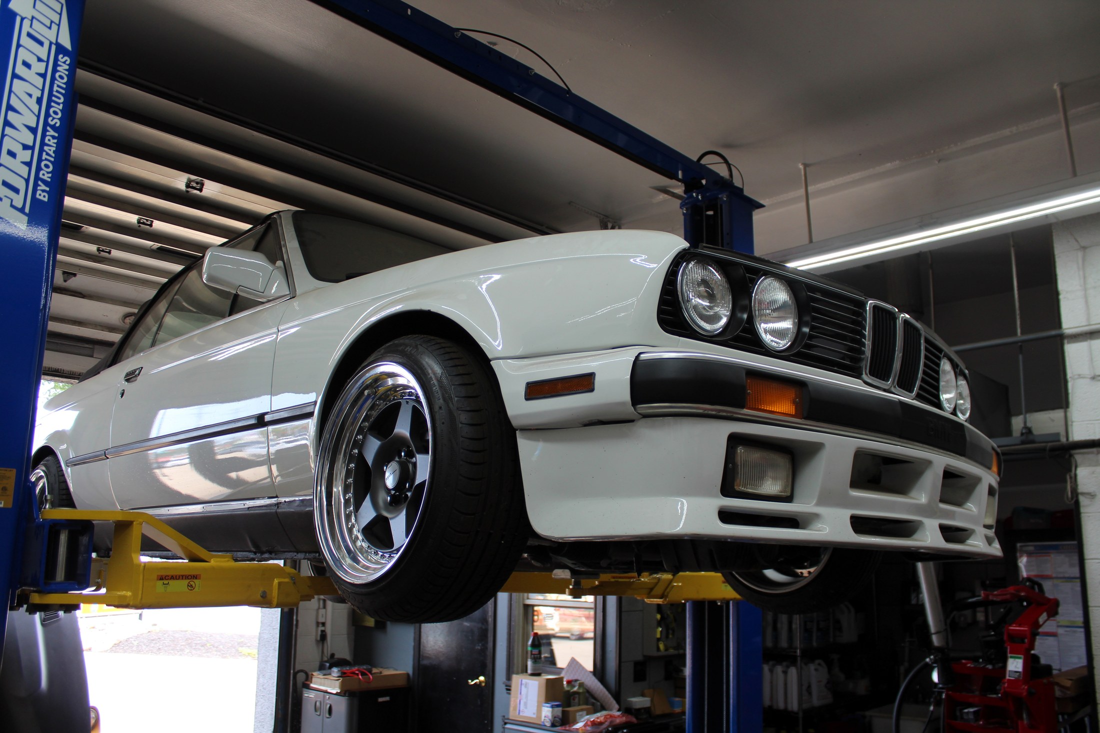 Vehicle raised on a lift for underbody service at Galati's Foreign Car Service
